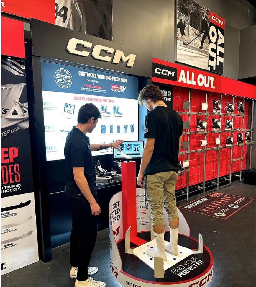 Store associate fitting a customer with the CCM 3D Fit Scanner